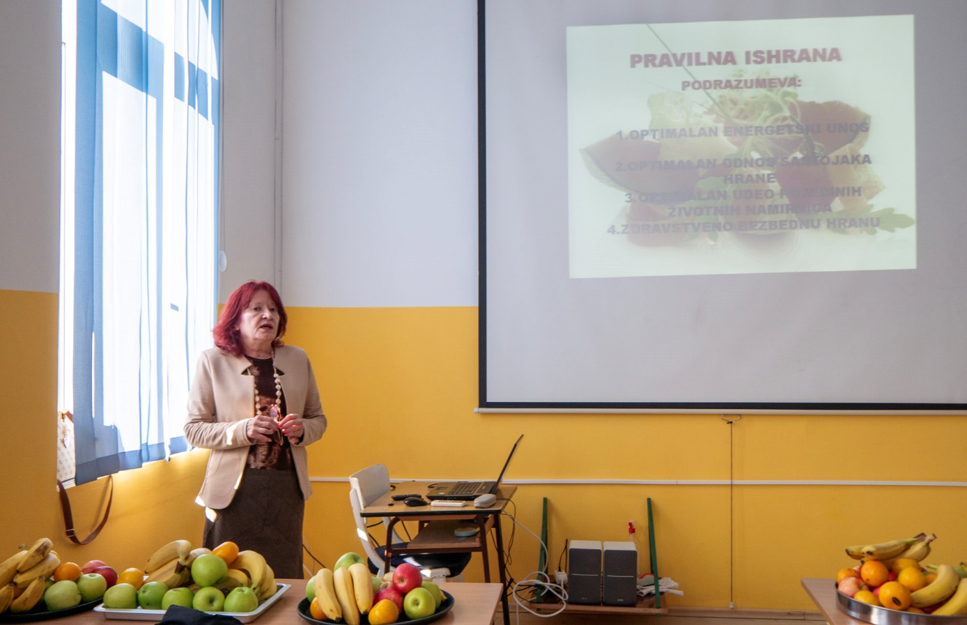 A person standing in front of a projector screen

Description automatically generated