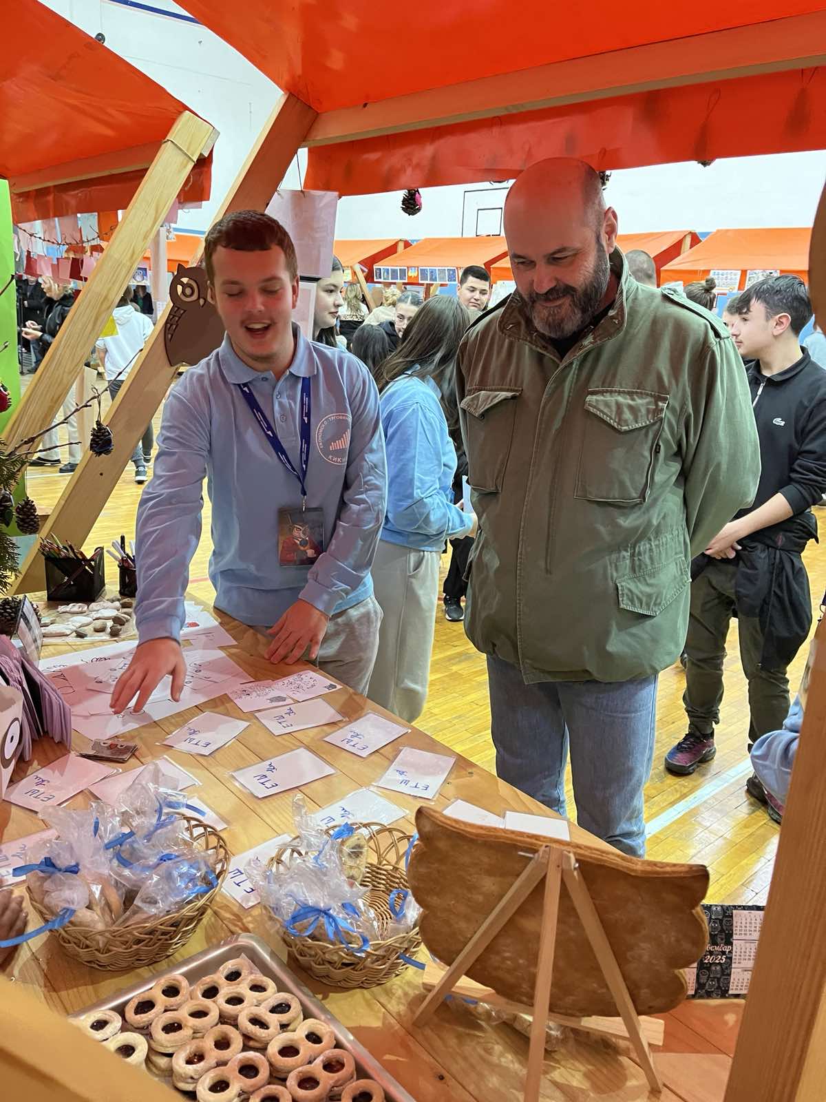 A group of men standing around a table with paper on it

Description automatically generated