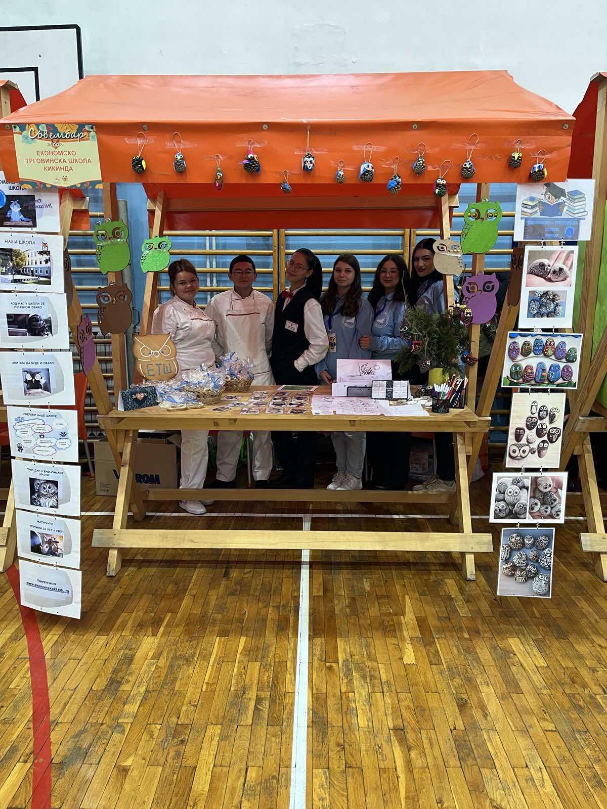 A group of people standing under a table

Description automatically generated